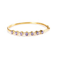 14K Yellow Gold Alternating Bezel Set 5MM Oval Shaped Tanzanite and 1/5 Cttw Diamond Bangle Bracelet (H-I Color, VS2-SI1 Clarity) - Fits wrists up to 7.25" Inches